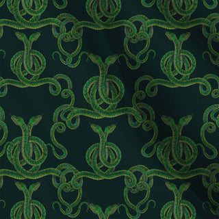 pattern of entwined green snakes on a dark green background shown as fabric