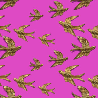 pattern of gold birds on a pink background