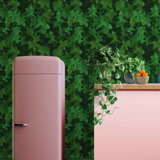 pattern of green bramble leaves shown as wallpaper with pink fridge and sideboard